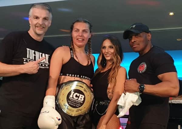 Champion Lucy Stirland with coaches Phil Swanwick (left), Rob Taylor (right) and a ring girl.