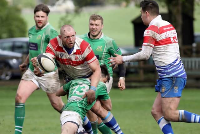 Lions forward Marius Andrijauskas is tackled but still gets the ball away against Wharfedale. Picture: Mick Sutterby