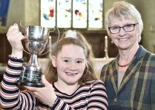 Drama Festival overall winner Daisy Reeves-Turner with her trophy presented by Festival Chairman   Pam Tedcastle. EMN-190605-094304009