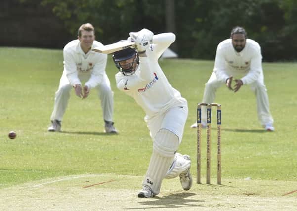 Josh Smith hits out during an innings of 63 for Peterborough Town at Oundle. Photo: David Lowndes.
