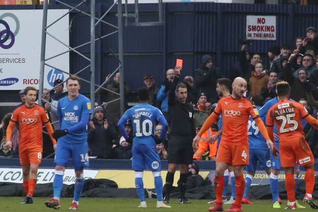 Posh defender Ryan Tafazolli is sent off at Luton.