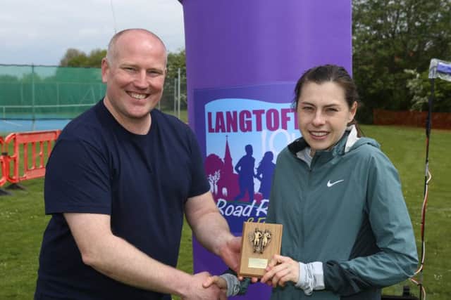 Chloe Finlay receives her prize from Langtoft Road Run committee member Dave Allen.
