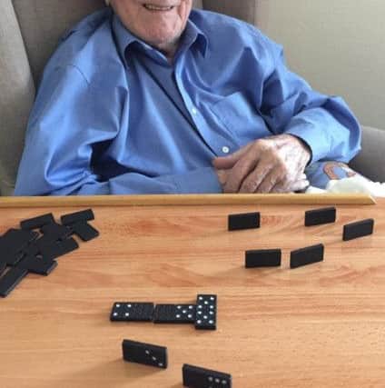 Bert playing dominoes
