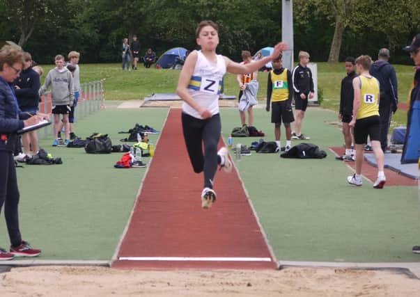 Ronnie Davey in action in the long jump.