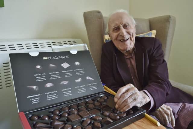 Bert with the recently discovered box of Black Magic chocolates EMN-191003-184120009