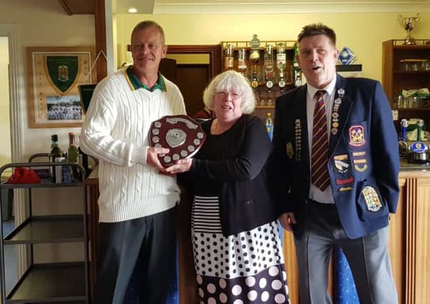 Mary Dickenson, widow of former English Bowling Federation stalwart John, presents the John Dickenson Memorial Shield to Whittlesey Manor club president Martin Welsford (left) watched by Northants Bowling Federation president Dick Noble. Whittlesey Manor were narrow winners of the annual match against a Northants Bowling Federation representative team on Saturday. Its the third time the season curtain-raiser has been staged in Johns memory.