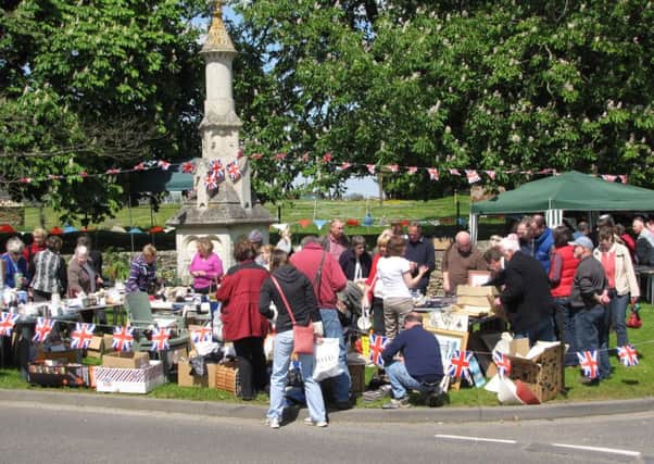 Stalls around the John Clare Memorial on the Village Green EMN-160525-100817001