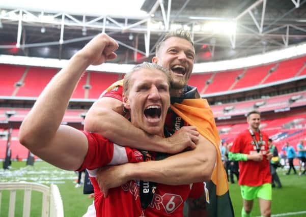 Carl Piergianni (fist raised) celebrates Salford's Wembley win.