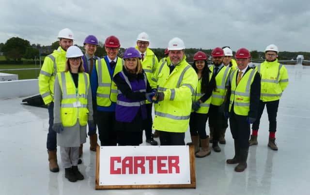 Representatives from the Jack Hunt School, R G Carter and Peterborough City Council at the topping out ceremony on the roof of Jack Hunt School extension.