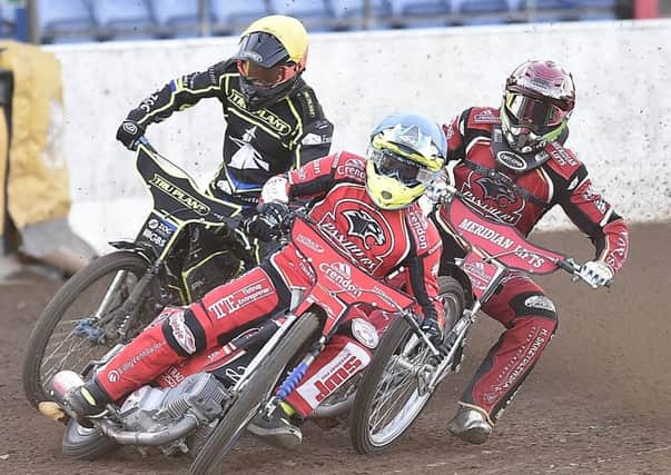 Charles Wright (red helmet) and Ben Barker (blue) contest heat five for Panthers against Ipswich. Photo: David Lowndes.