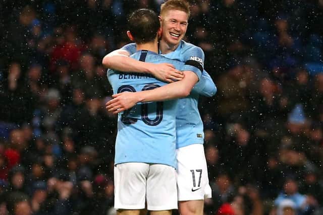 Manchester City players Bernardo Silva and Kevin De Bruyne celebrate the Premier League title win.