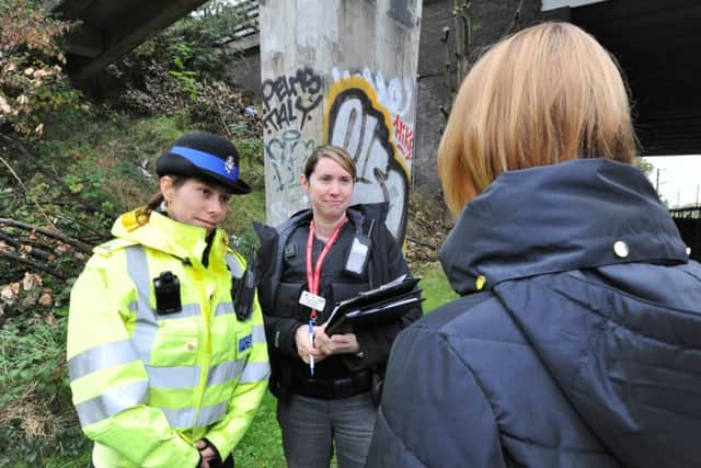 Police officers putting out notices and talking to passers-by on a walkway between Rhubarb Bridge at North Bretton - the scene of a recent assault EMN-170710-200908009