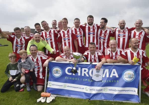 Peterborough Sports celebrate their Veterans Cup Final success. Photo: David Lowndes.