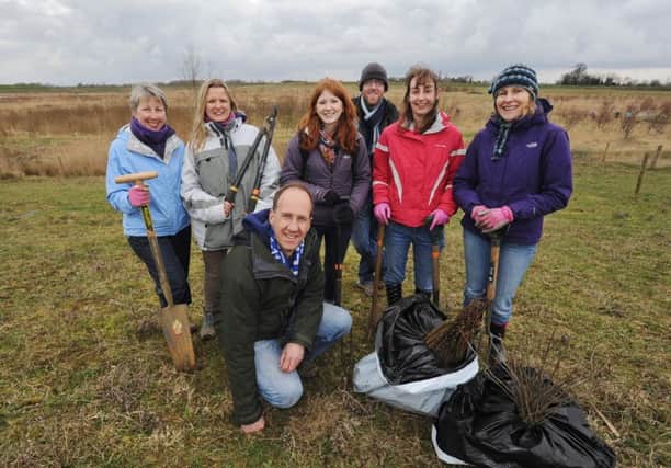 Richard Astle from the Langdyke Trust at Maxey-Etton pits for a day of hedge planting with volunteers (back l-r), Anne Curwen, Jessica Pryor, Fiona Moore, Nicholas Godman, Eleanor Devenish, Sara Branch EMN-140228-155643001