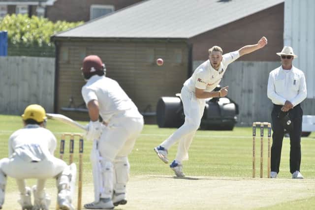 Rob Sayer bowling for Peterborough Town against Geddington. Photo: David Lowndes.