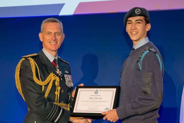 Alex is presented with the award