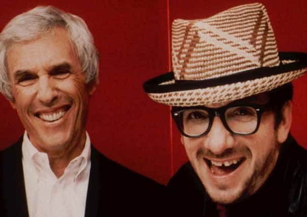 Burt Bacharach, left, and Elvis Costello pose in this 1998 promotional photo for their collaborative album, "Painted from memory."