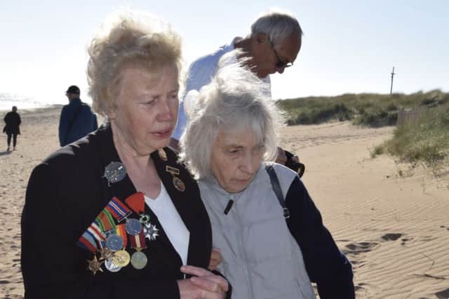 Ann Howard and Winifred Davis laying a wreath at Juno Beach on behalf of the Peterborough Normandy Veterans Association