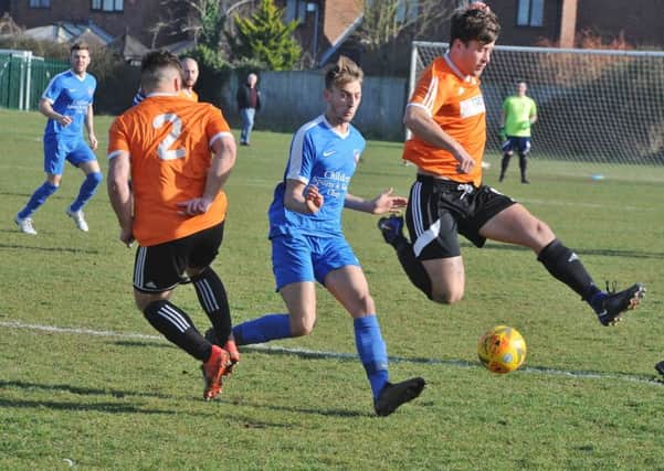Thorney FC (orange) in action last season.