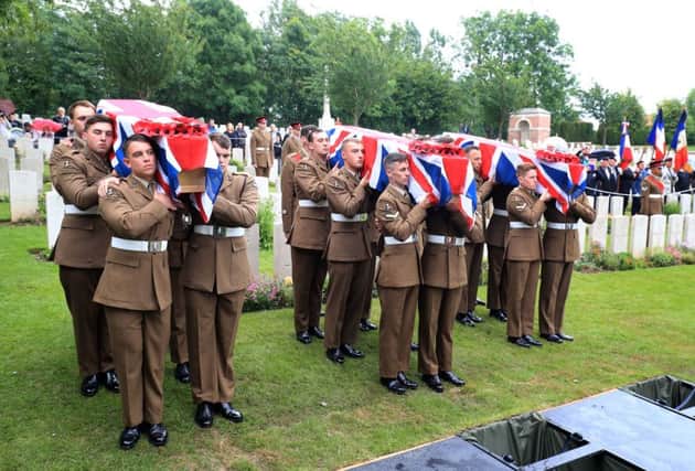 Soldiers of the Princess of Wales Royal Regiment carry the coffins of two young privates and an unknown soldier, who fought during World War One, into Hermies Hill British Cemetery near Albert, France. Photo: Gareth Fuller/PA Wire