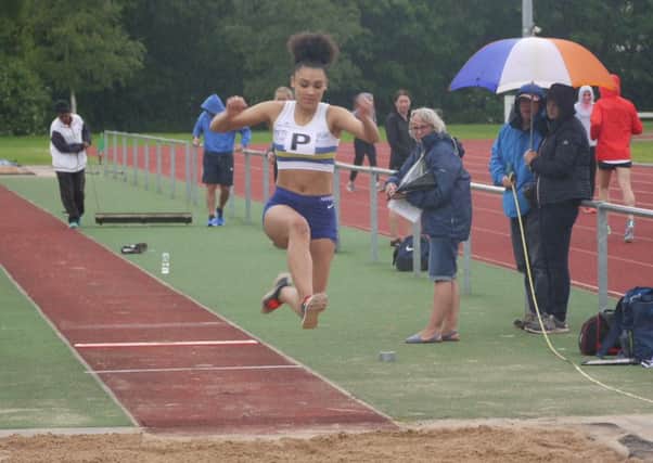 Jamelia Henson on her way to winning the triple jump for PAC.