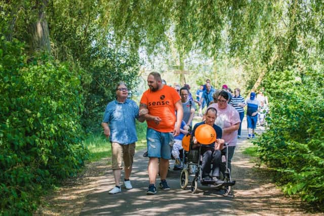 Staff and people with complex disabilities from the Sense centre in Peterborough participate in last years walk