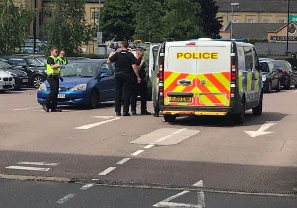 Police examine the blue Honda