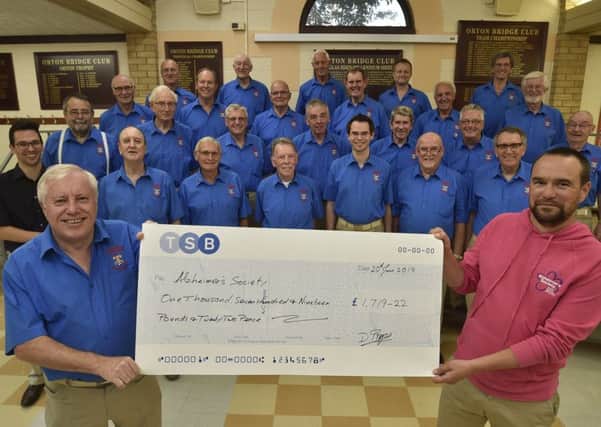 Alan Lunn and members of the Hereward Harmony Barbershop Harmony Club presenting a cheque for £1,719 to Gary Sutcliffe from the Alzheimer's Society EMN-190620-221758009