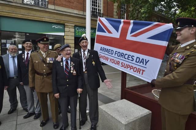 Monday's armed services flag flying at Peterborough Town Hall. Veterans with Lt Col Andrew Gifford and Cpt Chris Hughes MBE from 158 Regiment RLC. EMN-190624-222014009