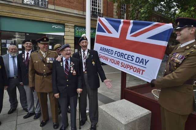 Monday's armed services flag flying at Peterborough Town Hall. Veterans with Lt Col Andrew Gifford and Cpt Chris Hughes MBE from 158 Regiment RLC. EMN-190624-222014009