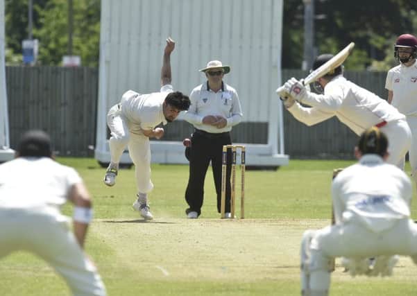 Danny Mohammed during a spell of 1-13 from six overs for Peterborough Town against Brigstock. Photo: David Lowndes.