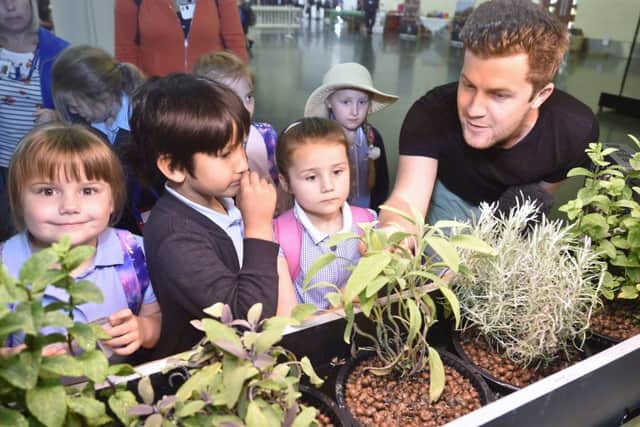 Schools Farming event at the East of England Arena.  Sam Cox from Rootlabs with children from Cavalry Primary School, March EMN-190107-144201009