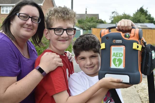 Gemma Saunders, a defibrillator fundraiser with her sons  Ben Saunders(13) and Bradley Venni (10) EMN-190307-090204009