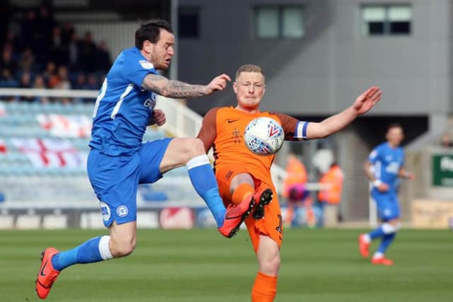 Lee Tomlin in action for Posh last season.