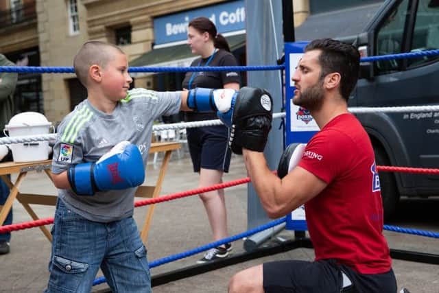 Chello Render gives boxing demonstrations as part of the Italia Festival. Pictured here with Tommy Robertson (8),City Centre, Peterborough07/07/2019. Picture by Terry Harris / Peterborough Telegraph. THA