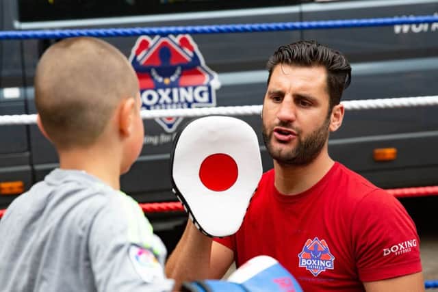 Chello Render gives boxing demonstrations as part of the Italia Festival. Pictured here with Tommy Robertson (8),City Centre, Peterborough07/07/2019. Picture by Terry Harris / Peterborough Telegraph. THA