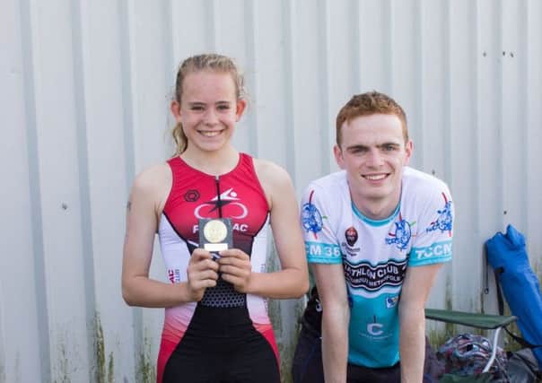 Calleigh Coull won the 11-12 year-olds race and received her trophy from Jonathan Oakley. Photo: Steve Hope.