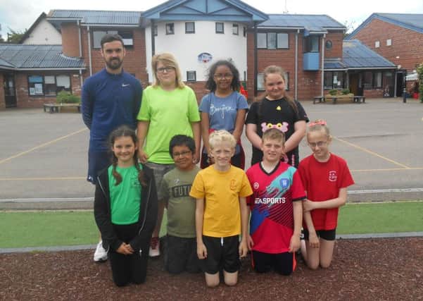 Pupils at Old Fletton Primary School who recently completed a sponsored walk with teacher Josh Pike