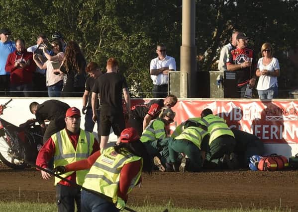 Medics attend to Josh Bates of Panthers after his heat two crash in the meeting with Belle Vue. Photo: David Lowndes.