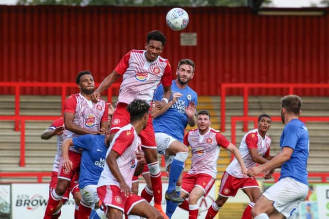 Jason Naismith challenges for a header. Photo: Joe Dent