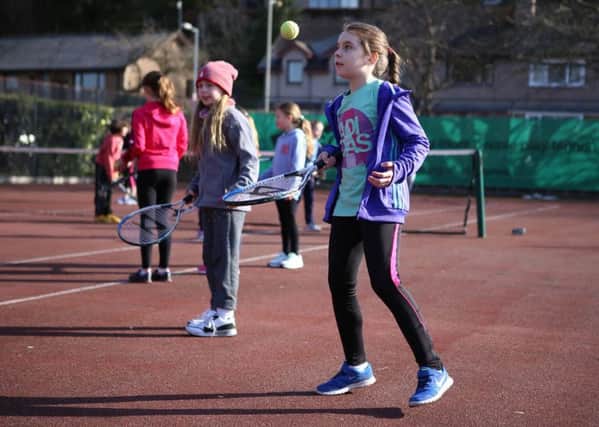 Youngsters enjoying tennis.
