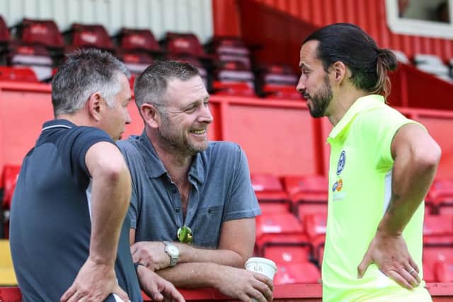 George Boyd with Posh chairman Daragh MacAnthony (centre) and Darren Ferguson (left). Photo Joe Dent/theposh.com.