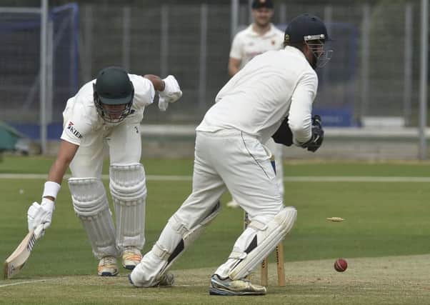 Peterborough Town's David Sayer just avoided being run out against Oundle here. Dan Robinson is the Oundle wicket-keeper. Photo: David Lowndes.