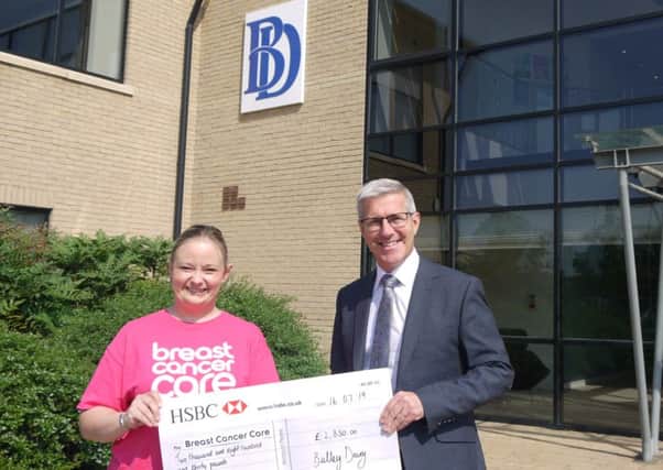 Emily Beahan  receives the cheque from Bulley Davey director, Mitchell Burden.