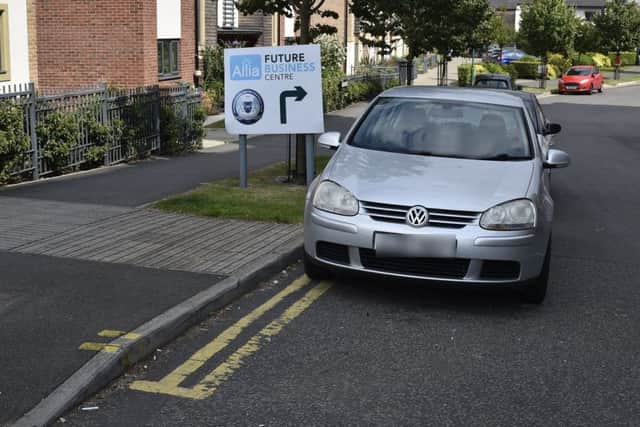 A car parked on the double yellow lines