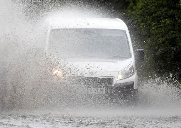 Cars make their way through standing water on the A47 near Peterborough after heavy rain fell throughout the country. Picture: Joe Giddens/PA Wire