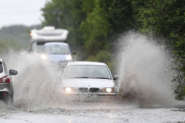 Cars make their way through standing water on the A47 near Peterborough after heavy rain fell throughout the country. Picture: Joe Giddens/PA Wire