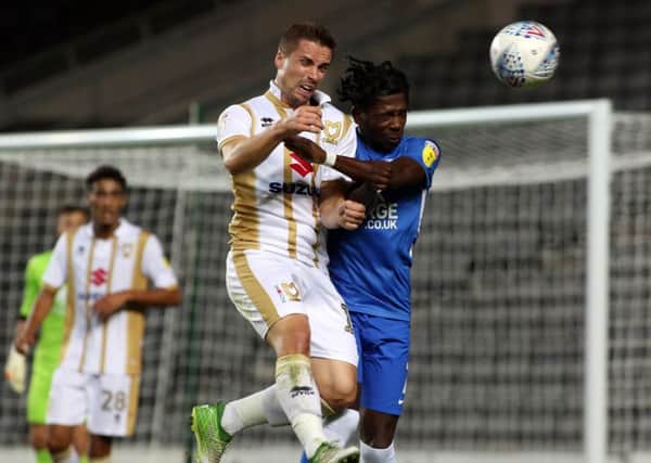 Isaac Buckley-Ricketts (right) in action for Posh at MK Dons last season.