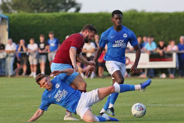 Youngsters Kyle Barker (prostrate) and Mikkel Fosu in action at Deeping. Photo: Joe Dent/theposh.com.