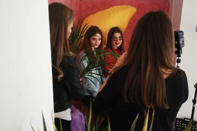 Two young people enjoying the Tagged and Filtered photo booth at the project launch earlier in the year